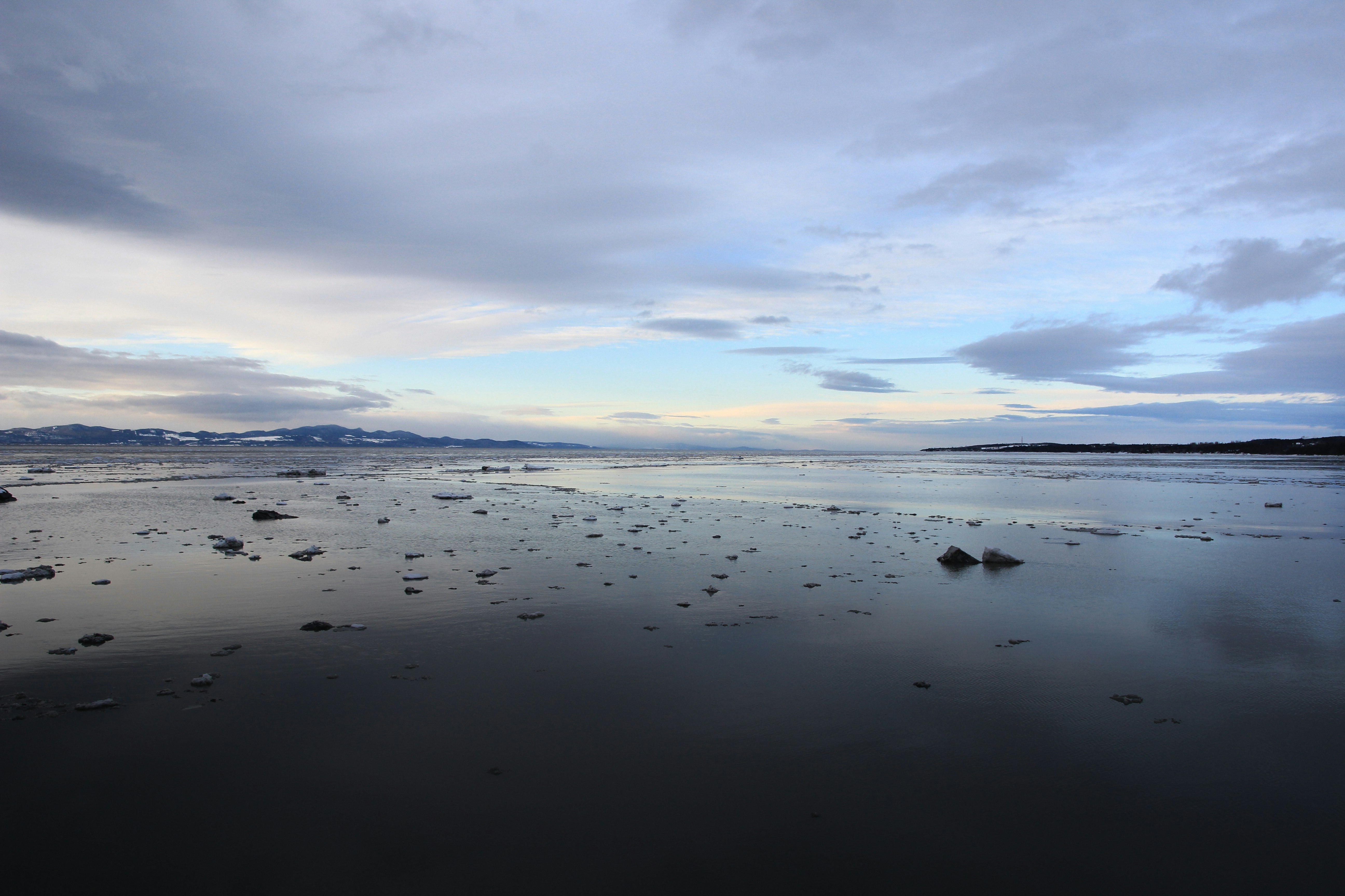 body of water under cloudy sky during daytime